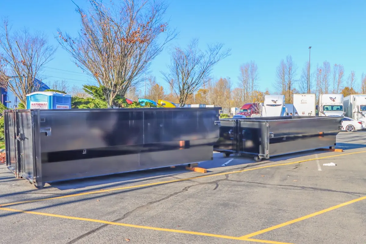 Professional dumpster rental service with roll-off container on residential driveway in Alachua